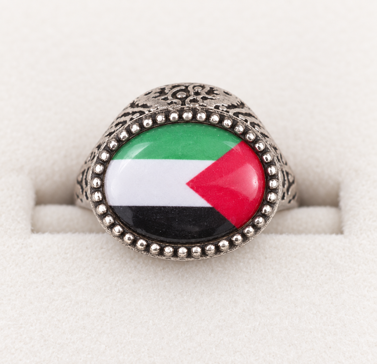 Silver-tone oval Palestine flag ring with a beaded rim and patterned shoulders.