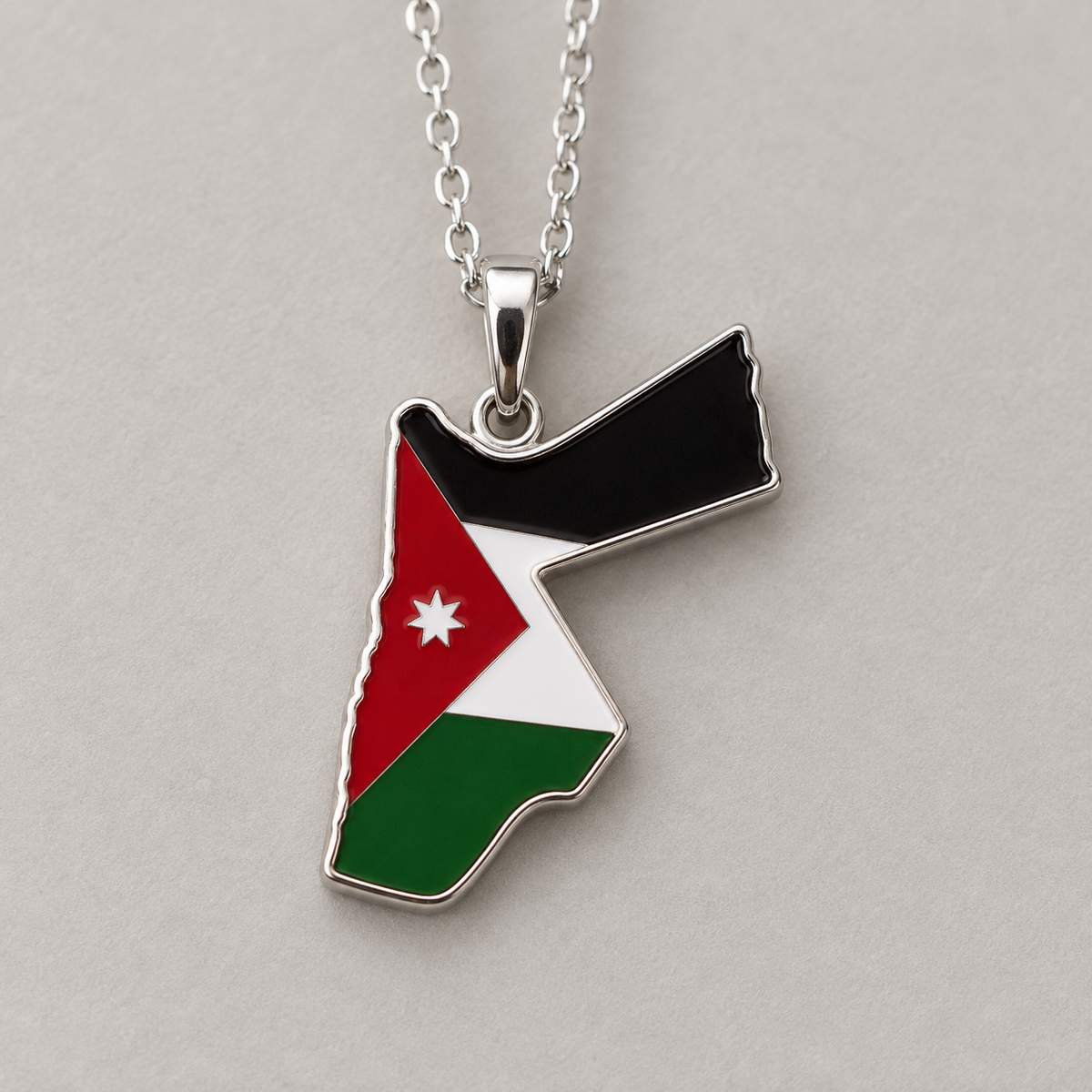 Detail of the Jordanian flag design and silver-tone border on a Jordan map pendant necklace.