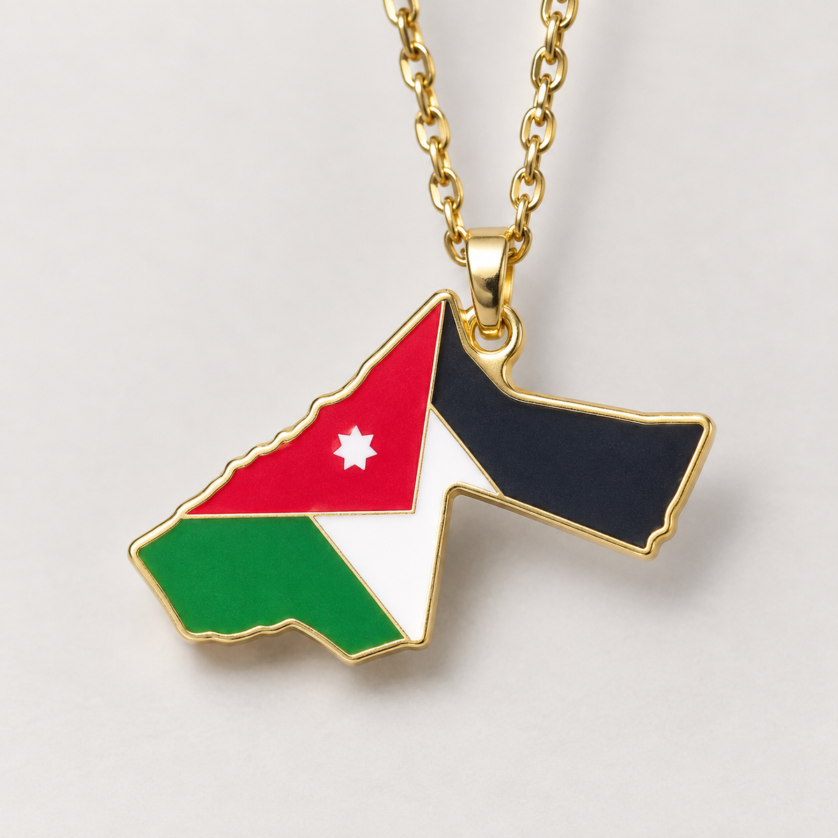 Detail of the Jordanian flag design and gold-tone border on a Jordan map pendant necklace.