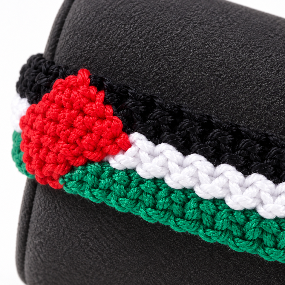 Close view of the red triangular accent and textured flag-color rows.