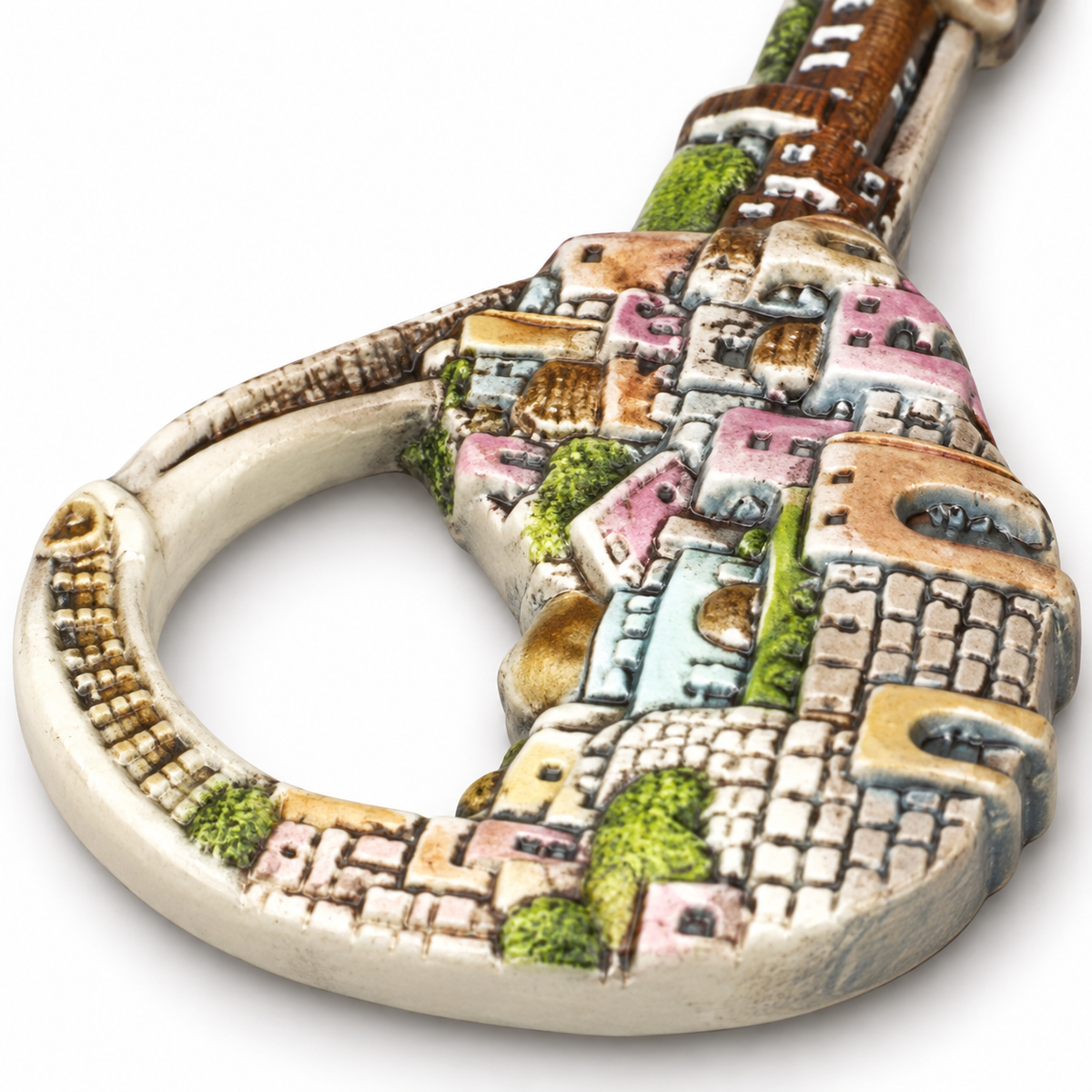 Close-up of the cityscape relief on the key's loop and upper shaft; the complete key is not shown.