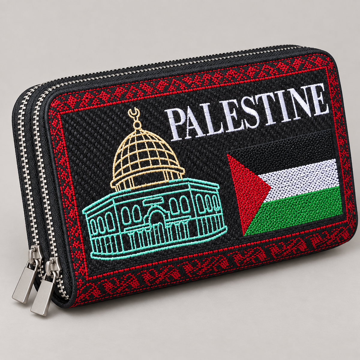 Close-up of the Palestine wallet's dome embroidery, flag motif and two silver-tone zipper tracks.